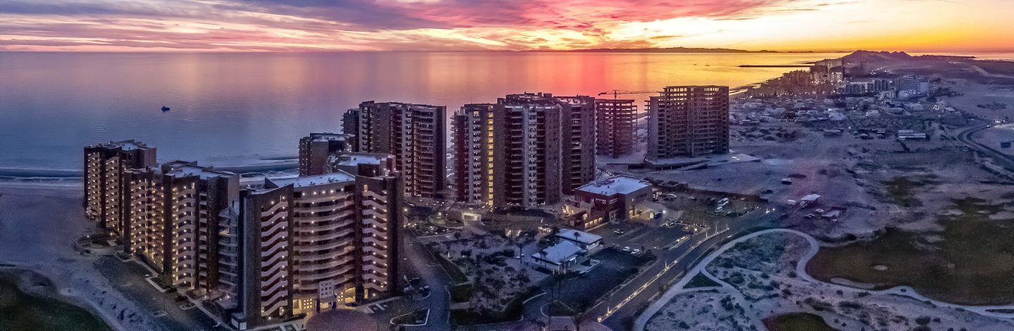 Beach with buildings with sunset