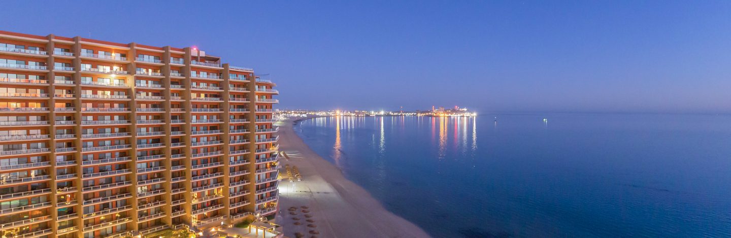 Building by the beach with the sea on the right