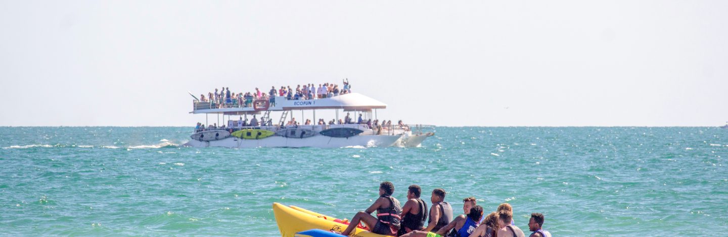 People on a waterbike with a boat in the background